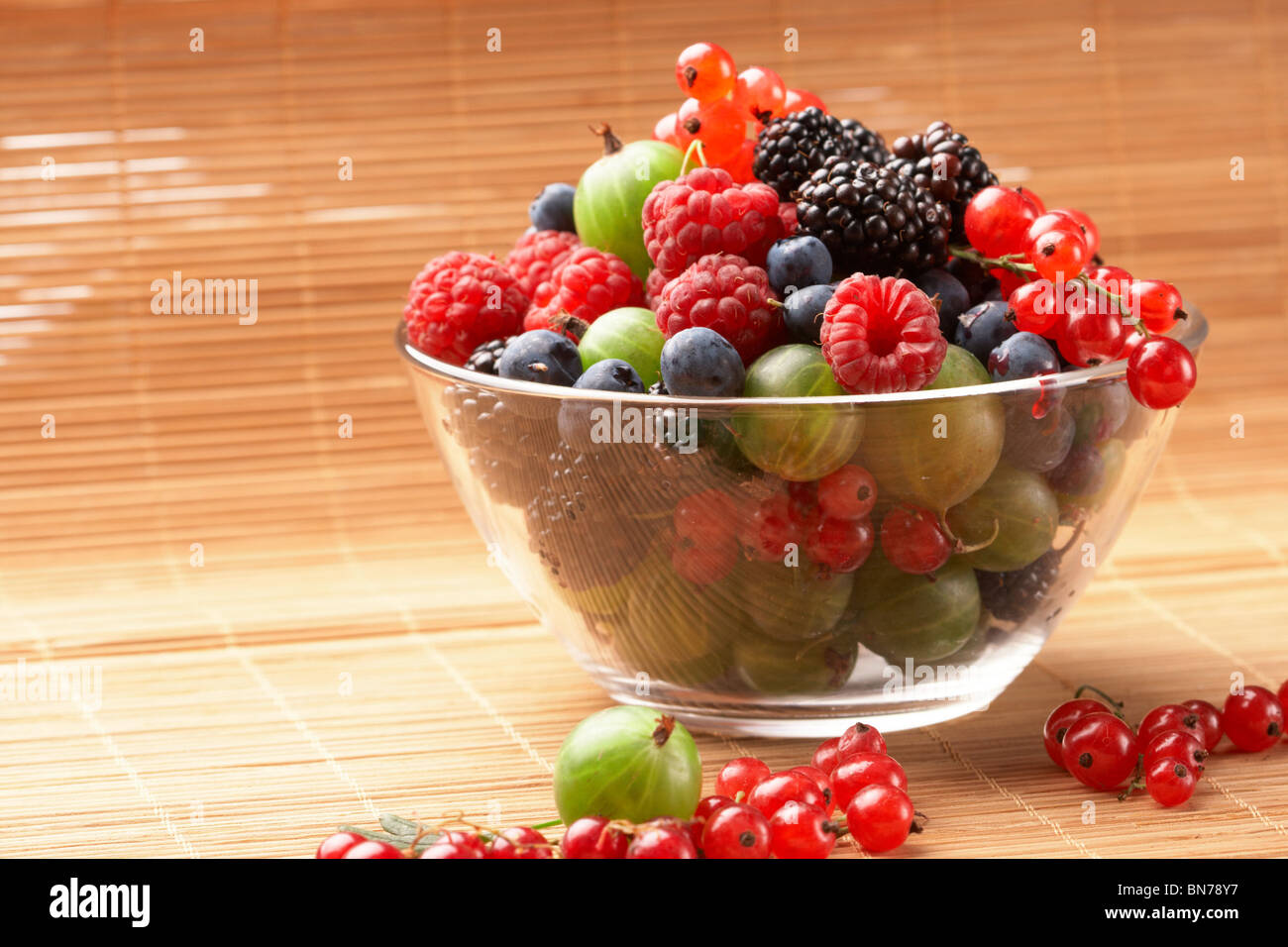 Fruit mix in the glass container, on a table from straw Stock Photo Alamy