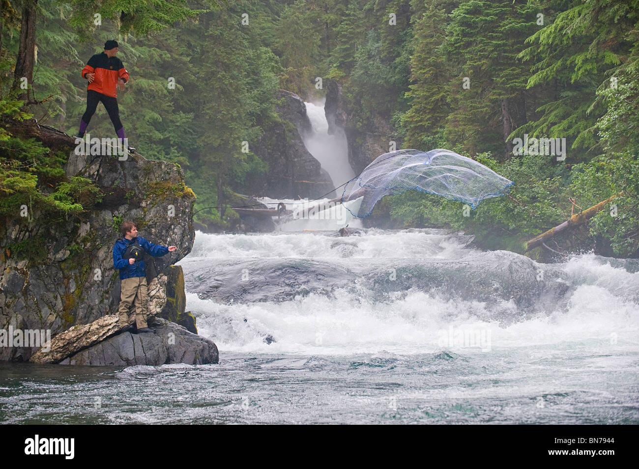 Two fishermen use a cast net to fish for Sockeye salmon in Sweetheart Creek  in Alaska Stock Photo - Alamy