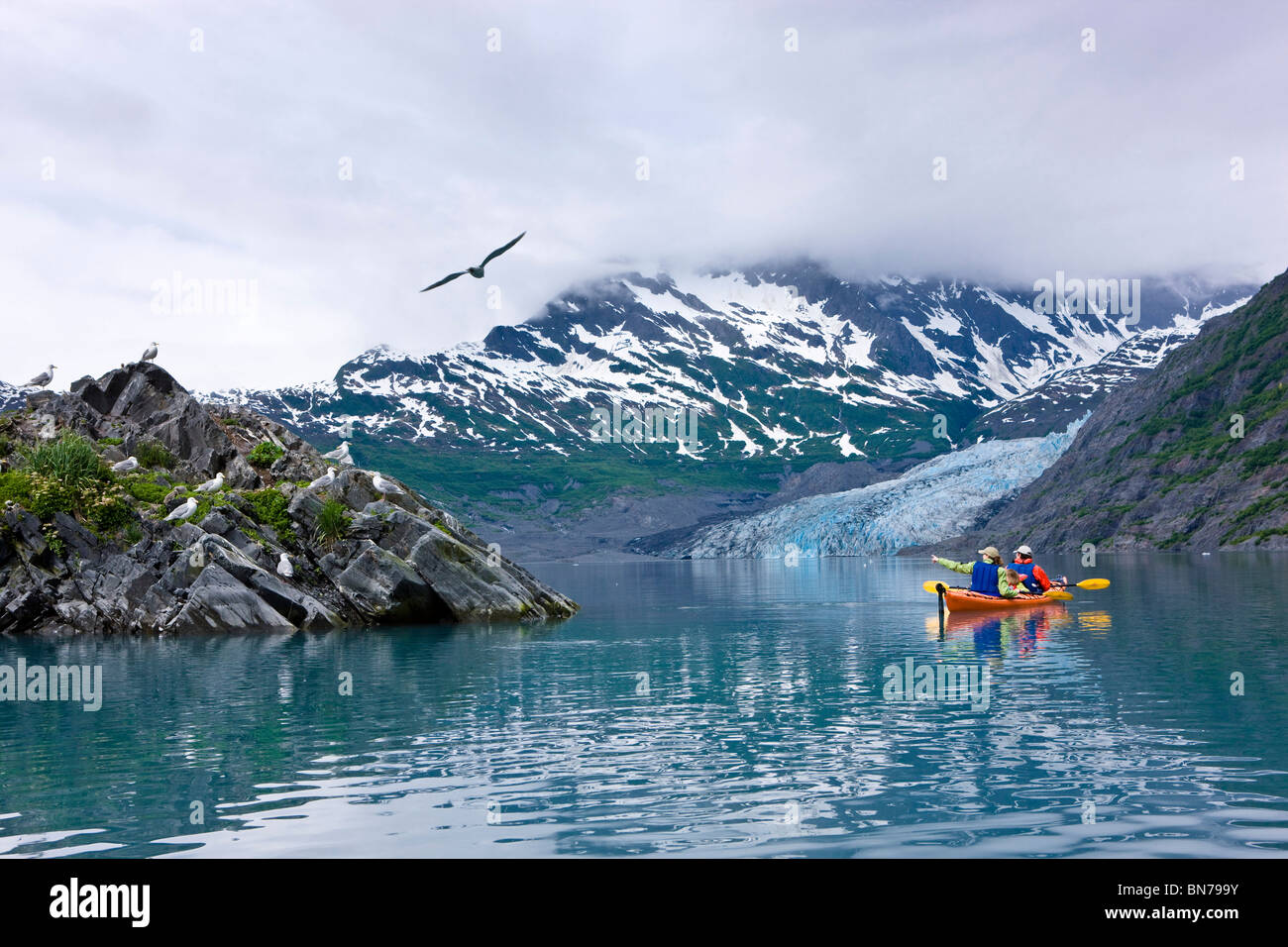 Family kayaking in Shoup Bay with Shoup Glacier in the background, Prince William Sound, Alaska Stock Photo