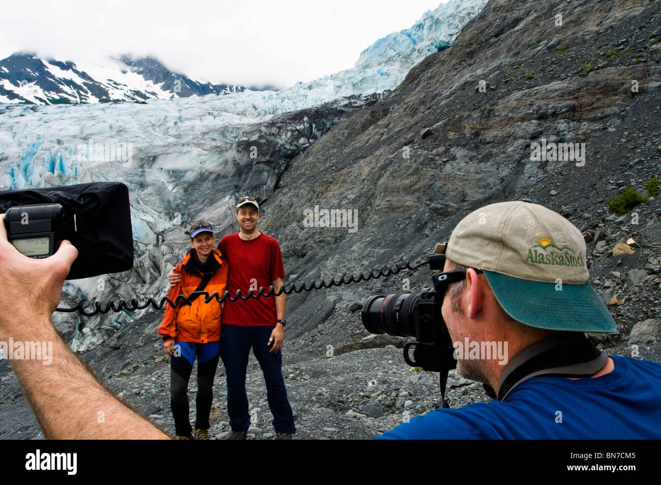 Photographer working with models in front of Shoup Glacier, Shoup Bay State marine Park, Prince WIlliam Sound, Alaska Stock Photo