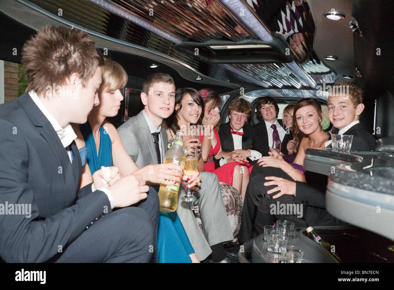 Teenagers inside their stretch limo going to their high school prom,  Cambridgeshire UK Stock Photo