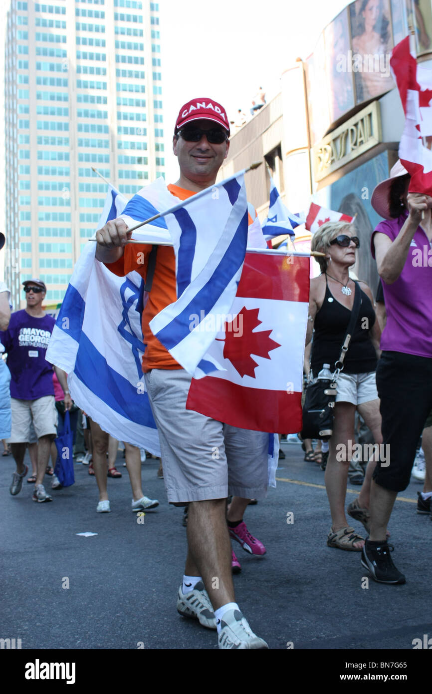 man carry israeli flag canadian flag Stock Photo