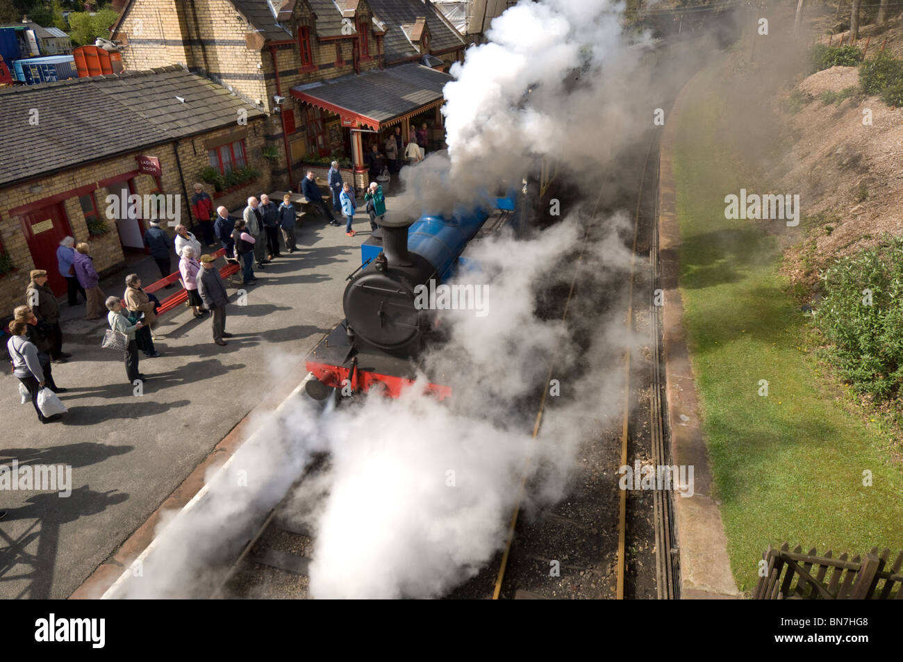 A blue steam locomotive train puffs into Haverthwaite station in the Lake District, Cumbria England UK on a preserved rail line. Stock Photo