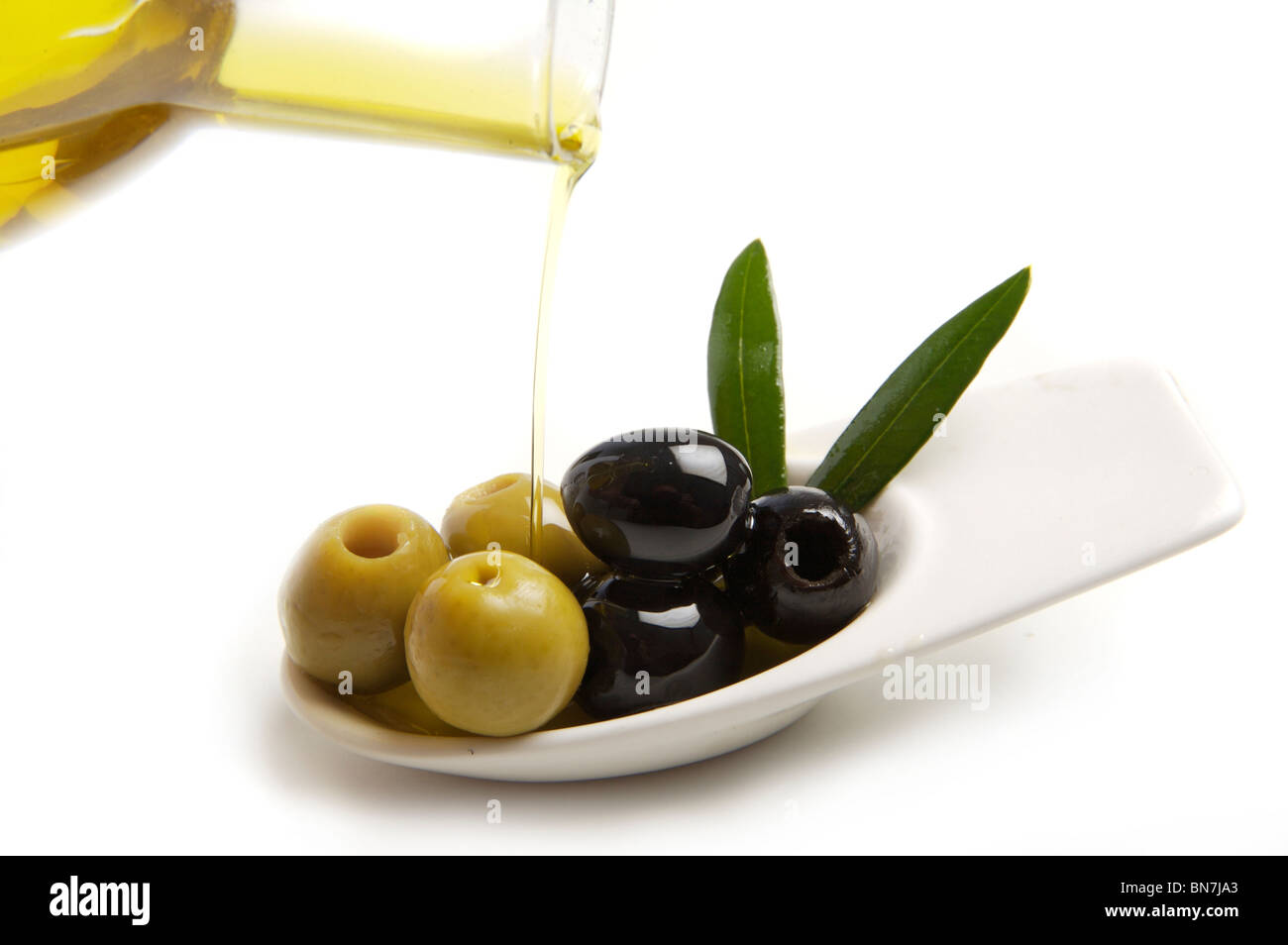 green and black olives with olive oil Stock Photo