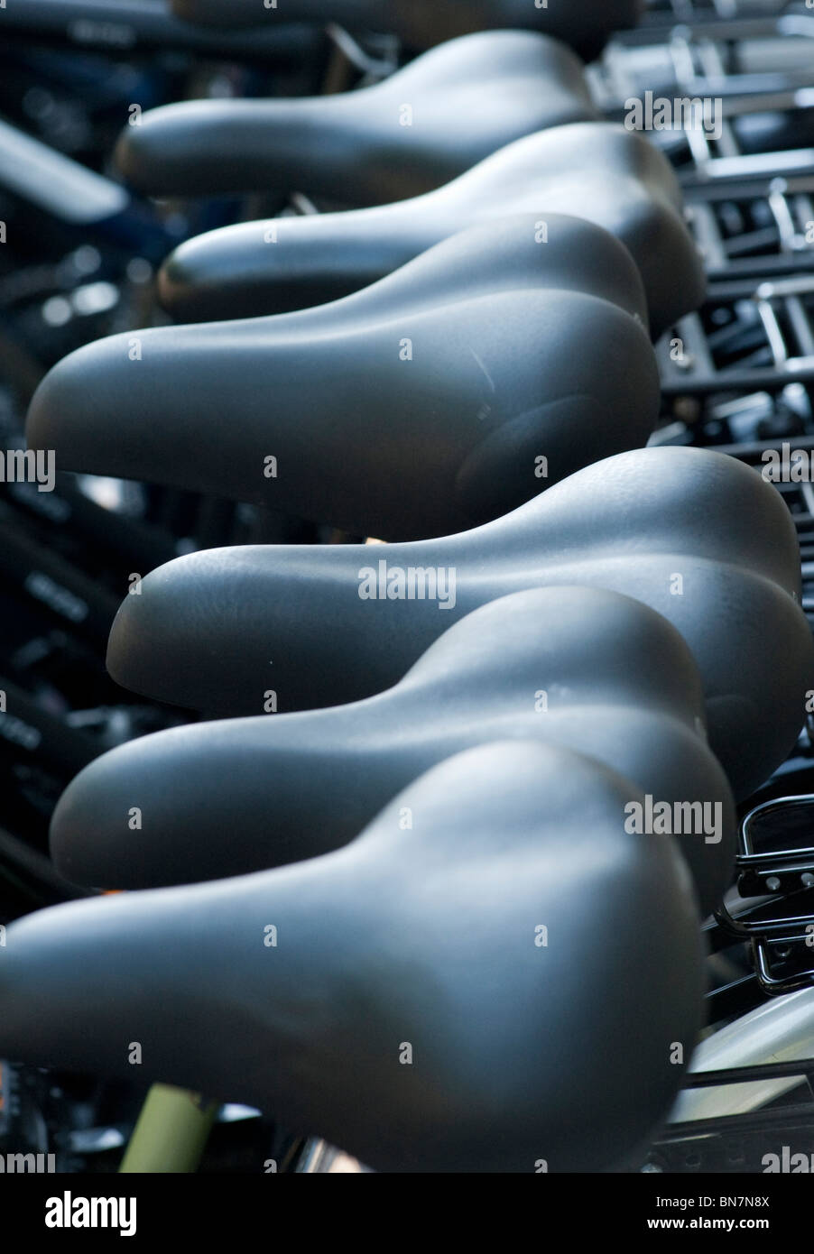 Close up of saddles on new bicycles for sale outside shop in Berlin Germany Stock Photo