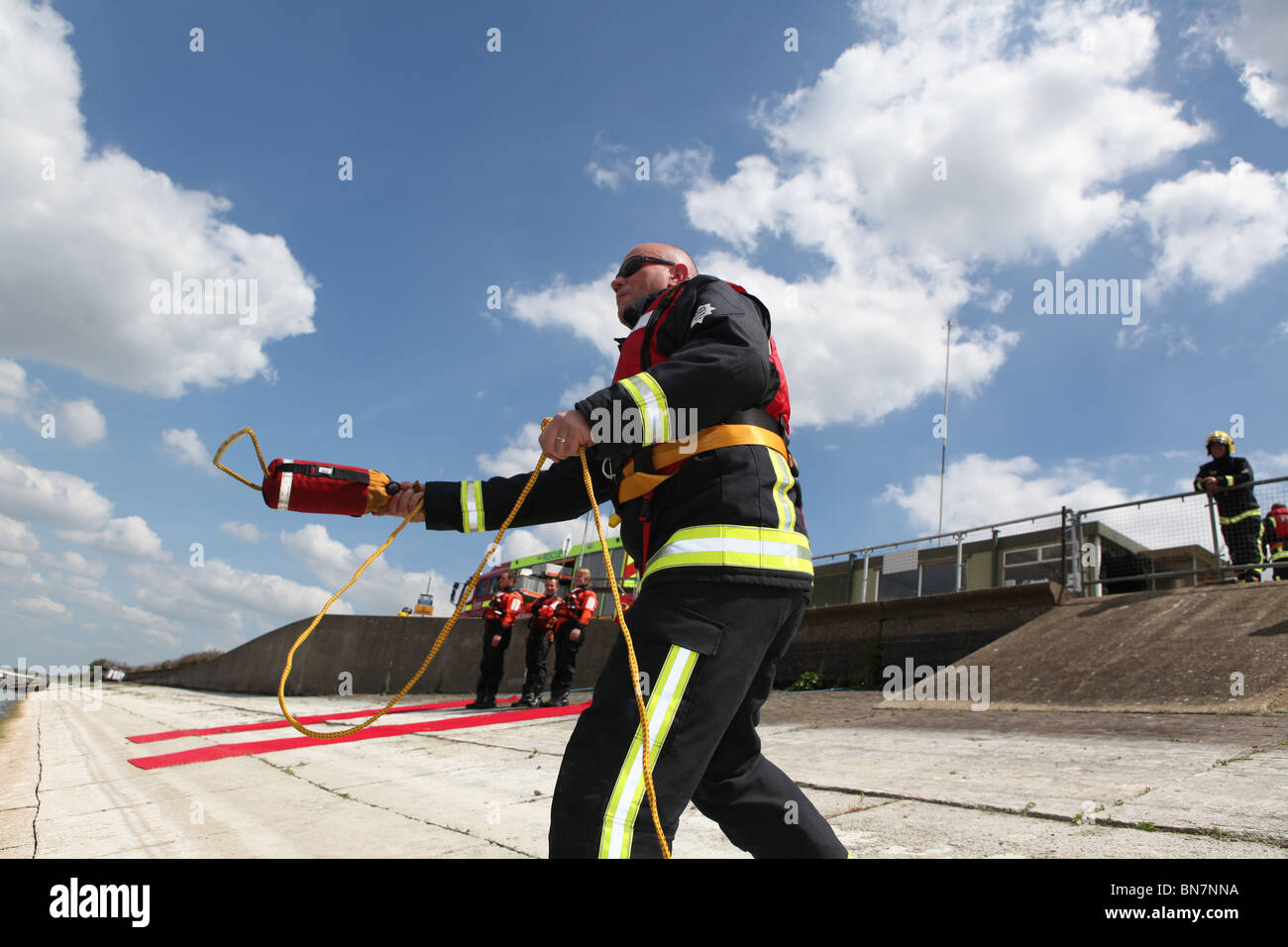 fireman training to save a person who is drowning in open water. they ...