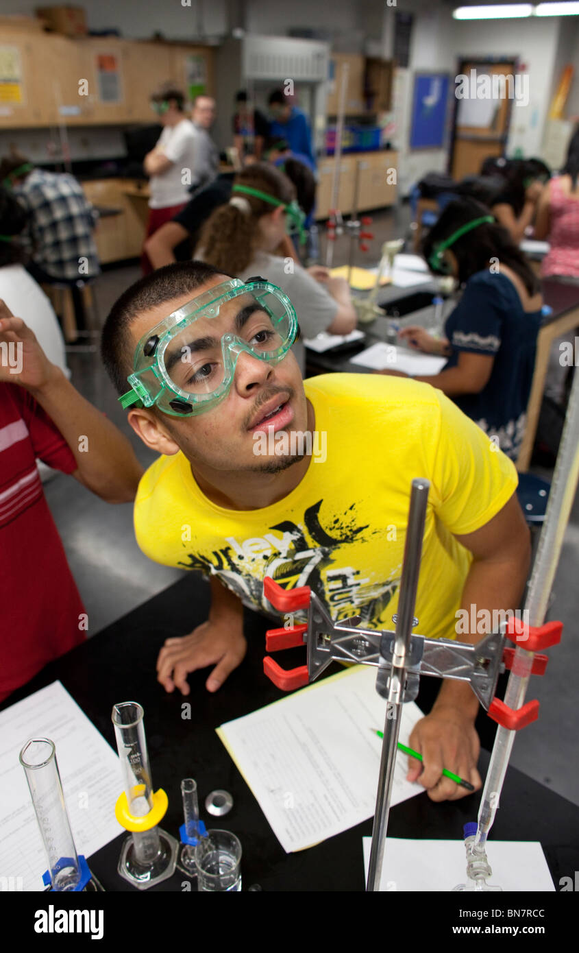 Student in safety goggles do an experiment in chemistry class at the Math, Engineering, Technology and Science Academy (METSA) Stock Photo