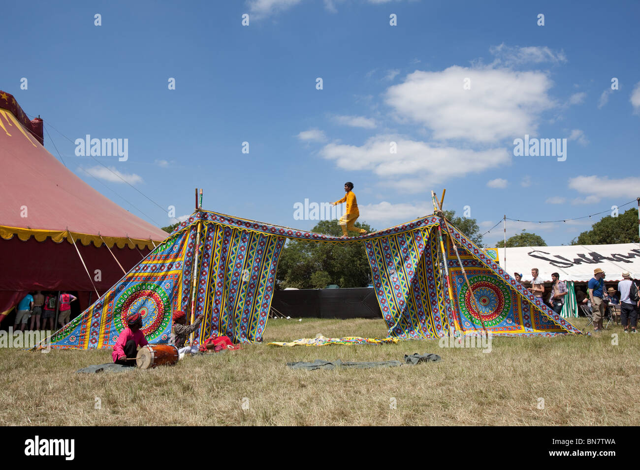 Indian tightrope walker at the Glastonbury Festival 2010, Worthy Farm, Pilton, Somerset, England, United Kingdom. Stock Photo