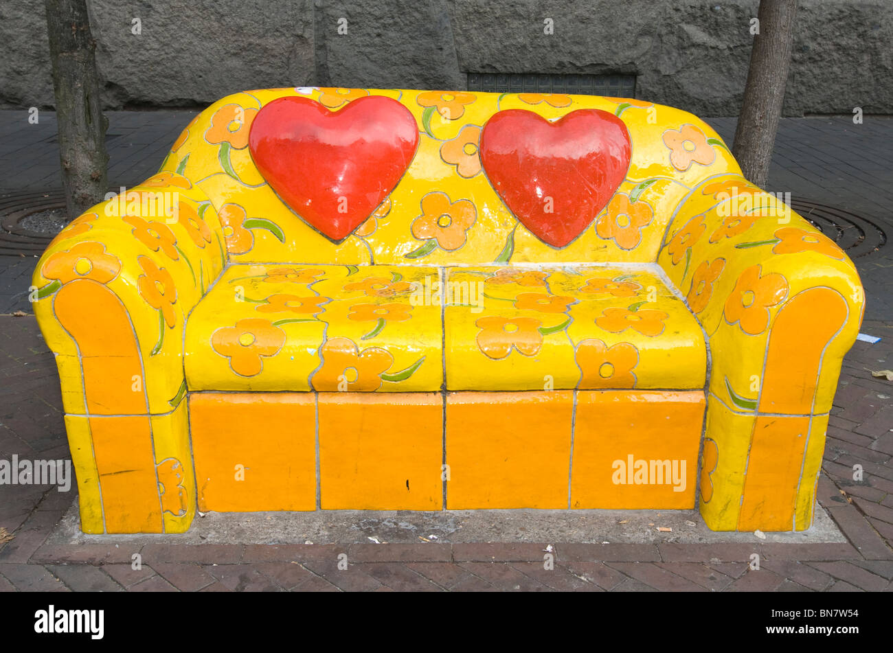 sofa couch stone painted tiles street amsterdam yellow flowers art netherlands bench Stock Photo
