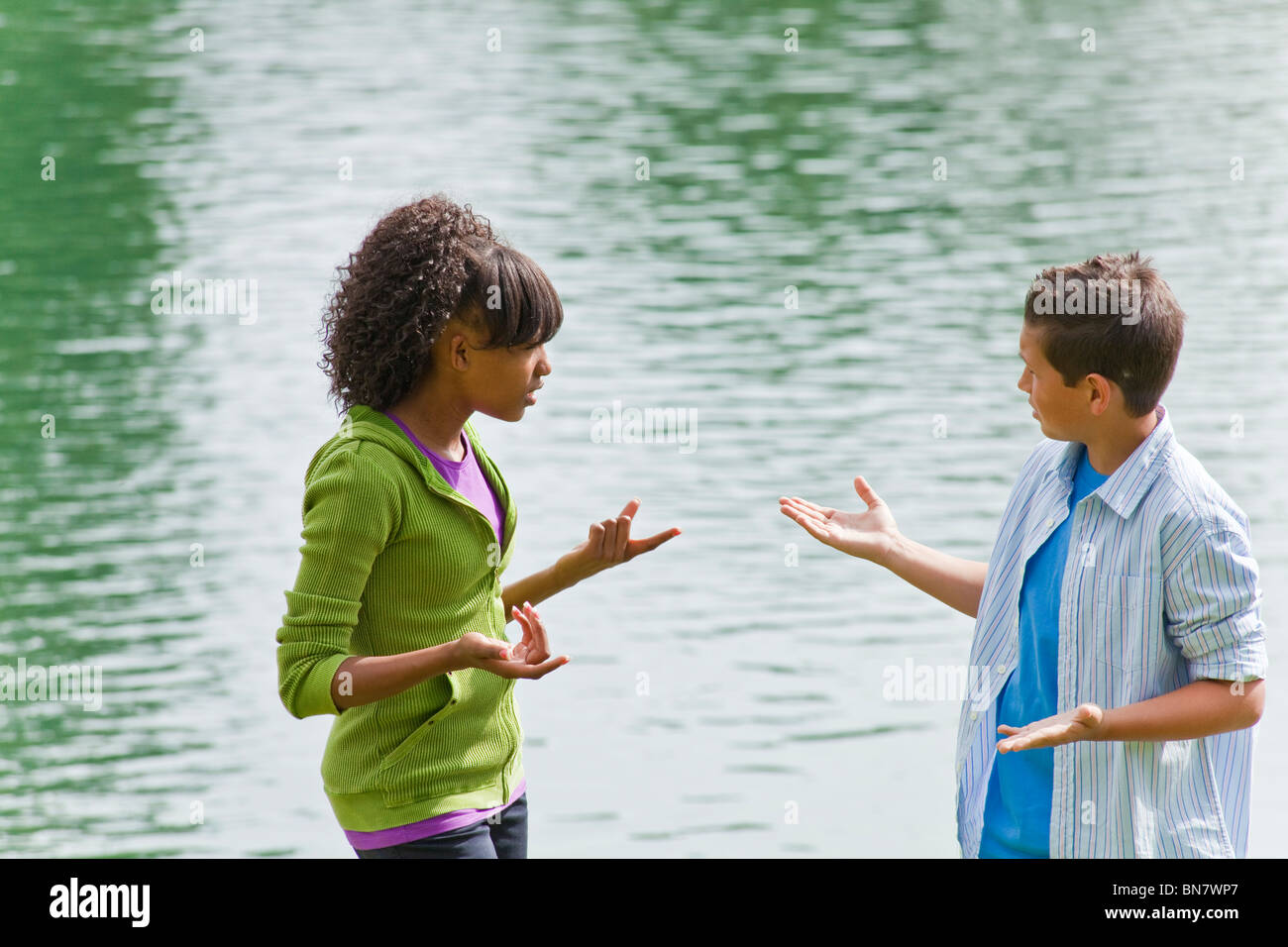 California Multi ethnic racial Ethnically diverse Girl and boy teens hanging out talking hand gesturing.  MR  © Myrleen Pearson Stock Photo