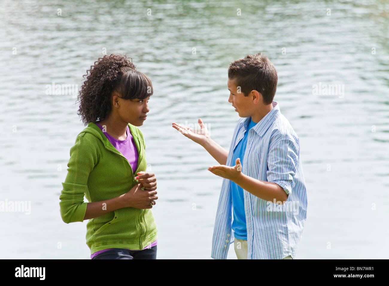 California Ethnically diverse teen kids hanging out talking with enthusiasm and hand gestures. MR ©Myrleen Pearson Stock Photo