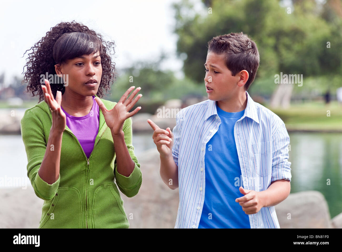 California Multi ethnic racial Ethnically diverseTeens hanging out gesturing Teenagers African American Girl Caucasian boy talking.MR ©Myrleen Pearson Stock Photo