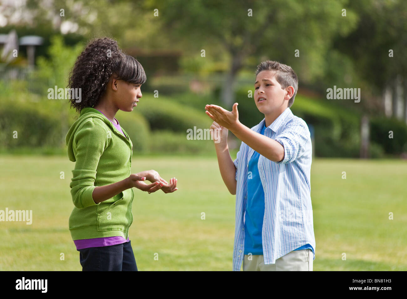 Boy and girl talking  ethnic multi racial diversity racially diverse Teens hanging out practice for debate team.  MR  © Myrleen  Pearson Stock Photo