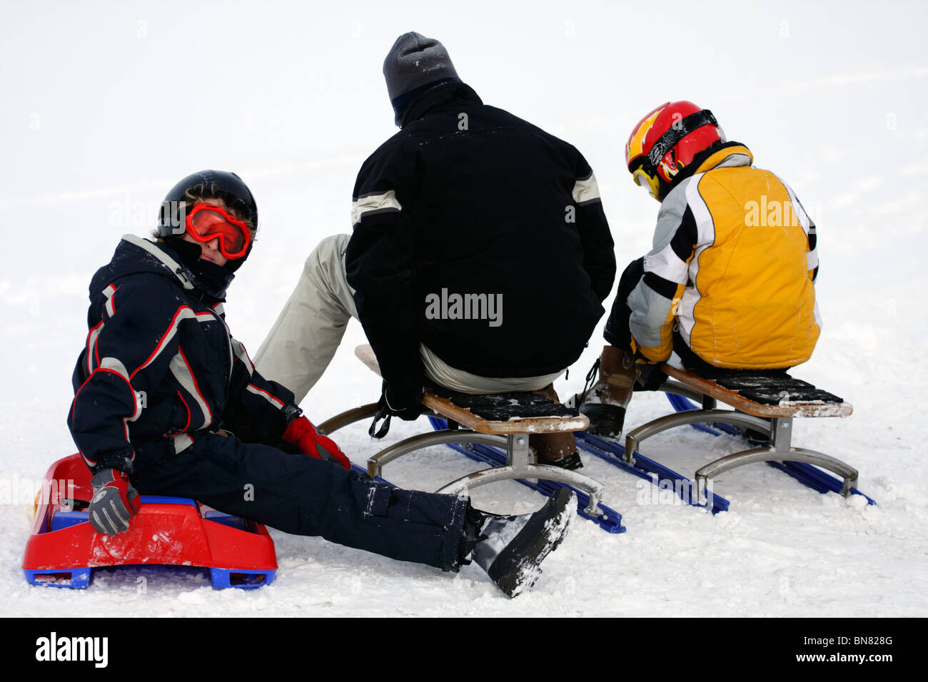 Man and two children with sleds, Switzerland Stock Photo Alamy