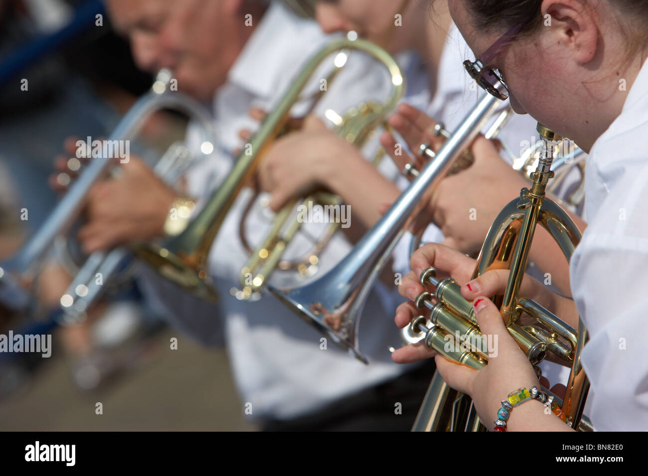 band members playing trumpets and in a traditional brass band
