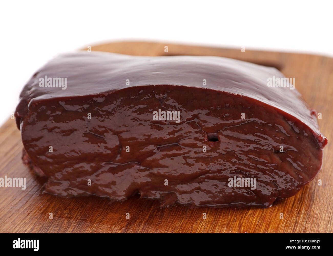 Veal liver part on wood board Stock Photo