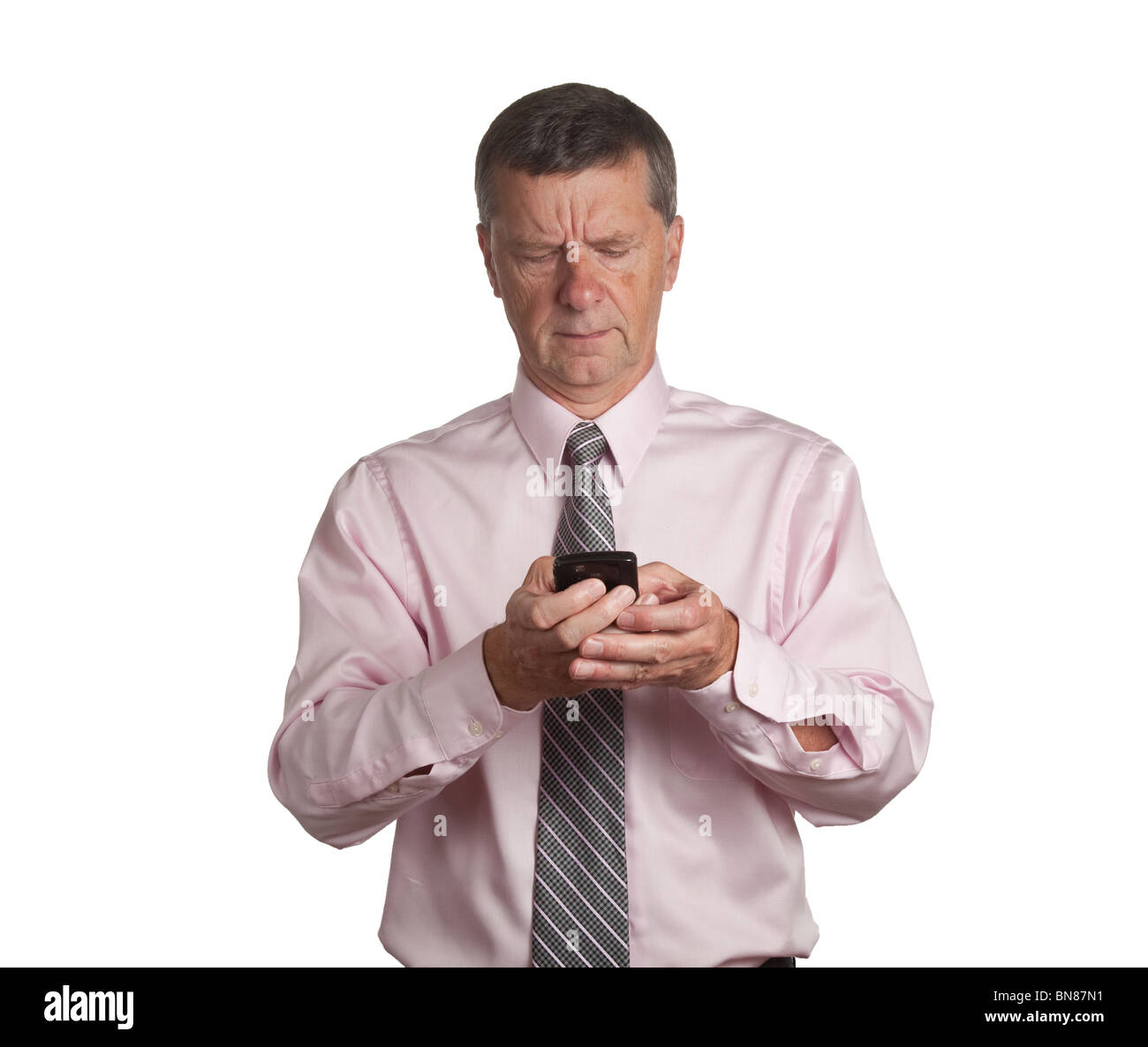 Senior businessman making an email on a blackberry type device Stock Photo