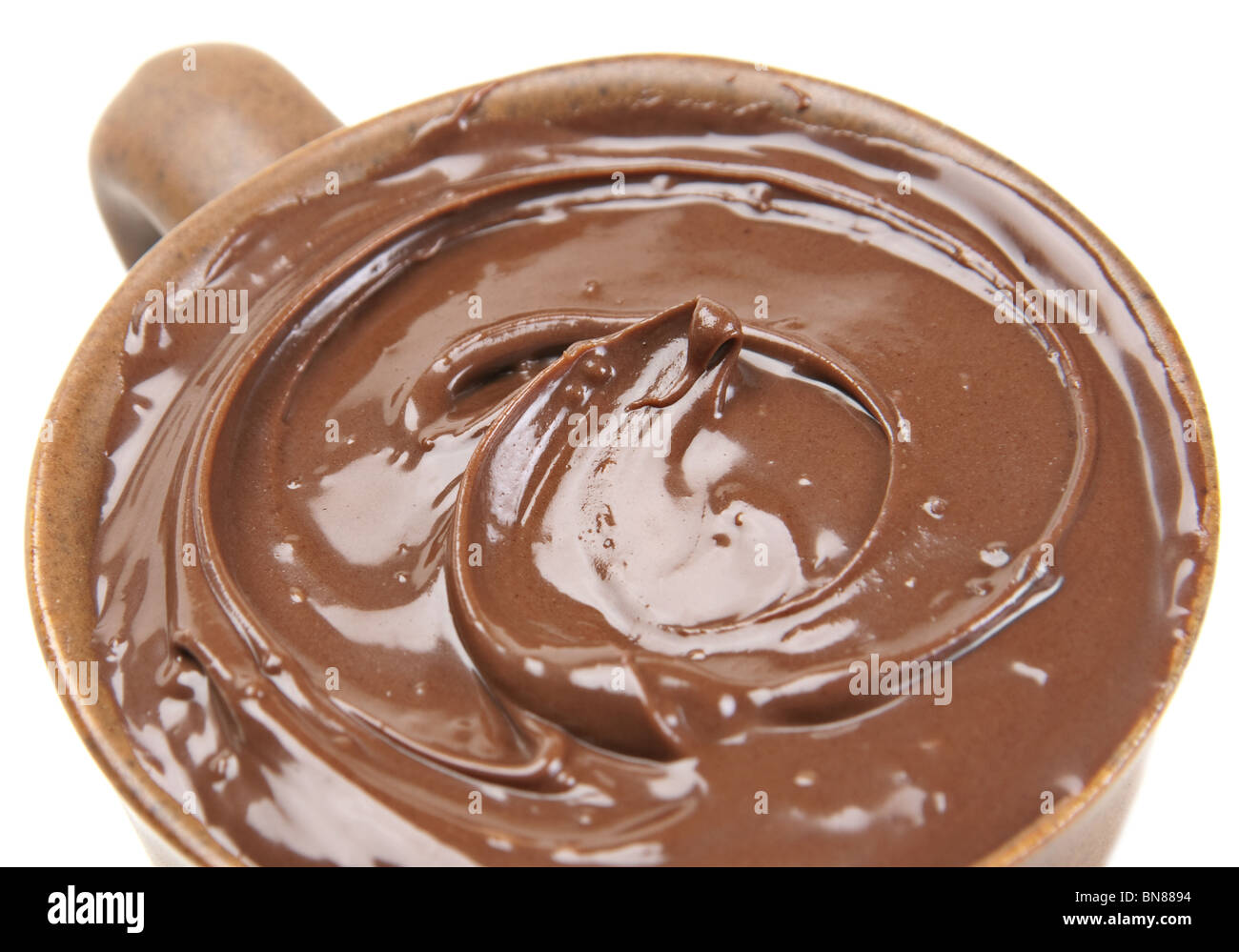 Nut cream with cacao in brown cup on white Stock Photo
