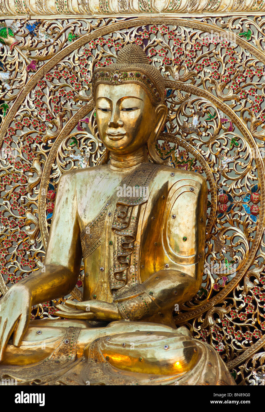 Golden Buddhist statue Stock Photo