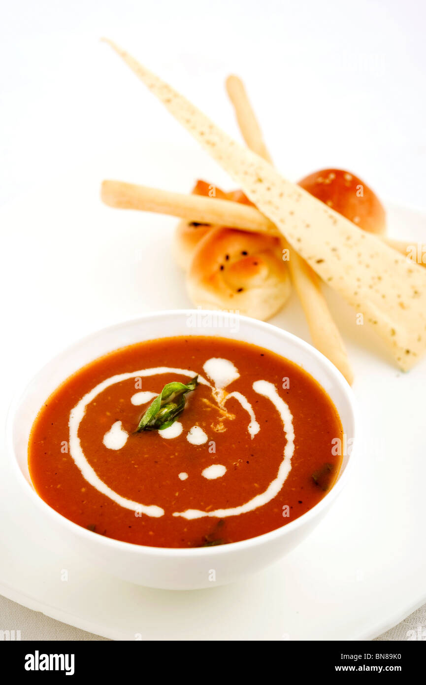 Basil Herbed Sun Dried Tomato Soup - Cream of fresh cherry tomatoes flavored with fresh basil and crushed garlic Stock Photo