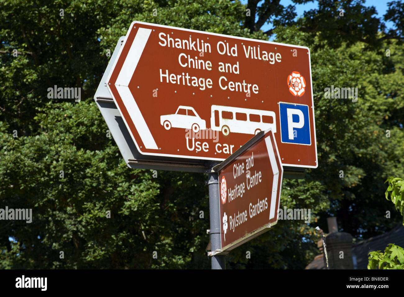 Brown tourist road signs to Shanklin Old Village, Chine and Heritage Centre and Rylstone Gardens, Isle of Wight, Hampshire UK in June Stock Photo