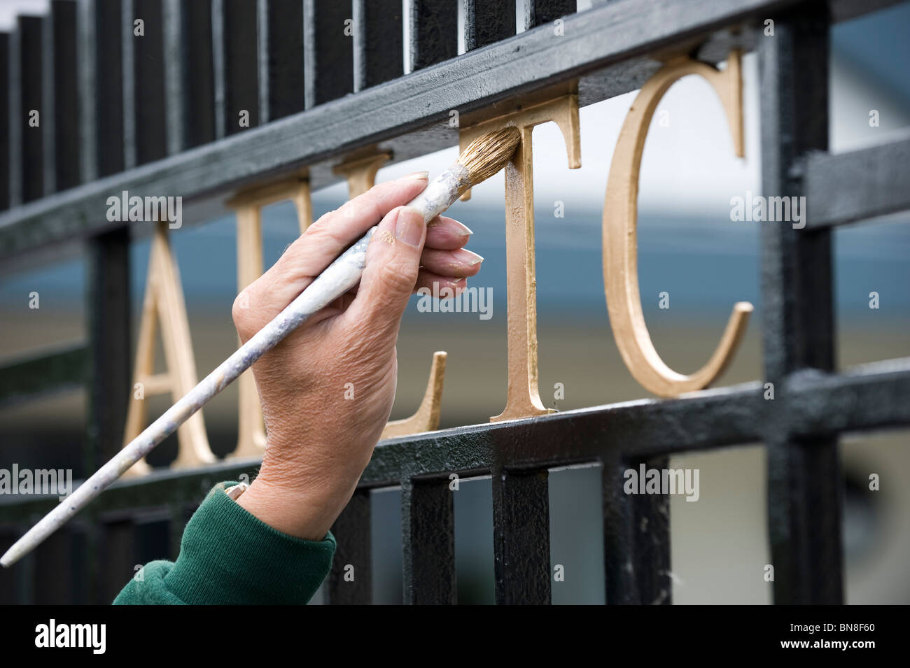 The AELTC sign on a gate is painted before the Wimbledon Tennis Championships 2010 Stock Photo