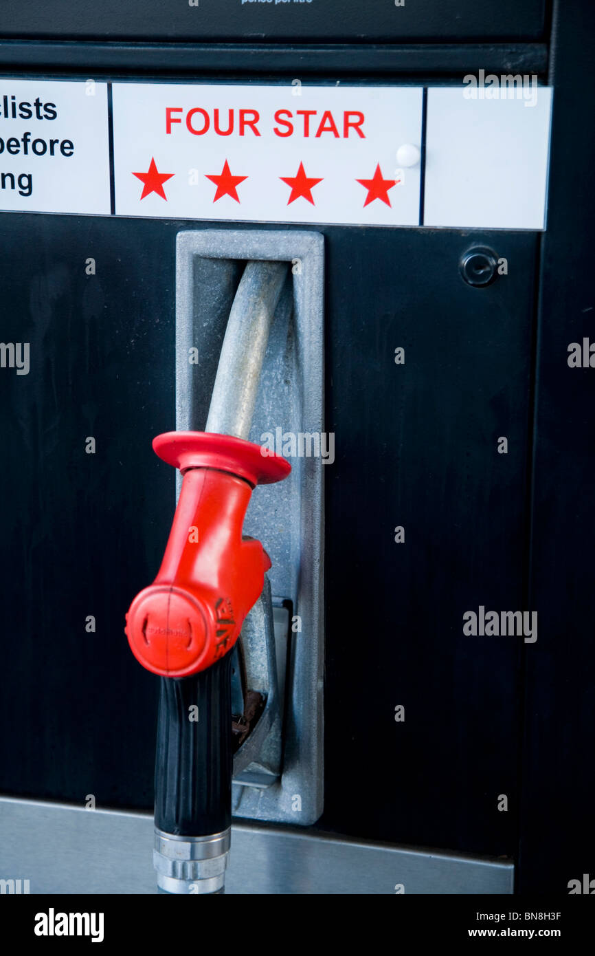 Four star / 4 star petrol pump knozzle at petrol station / old obsolete old vintage pumps at filling station garage forecourt. UK Stock Photo