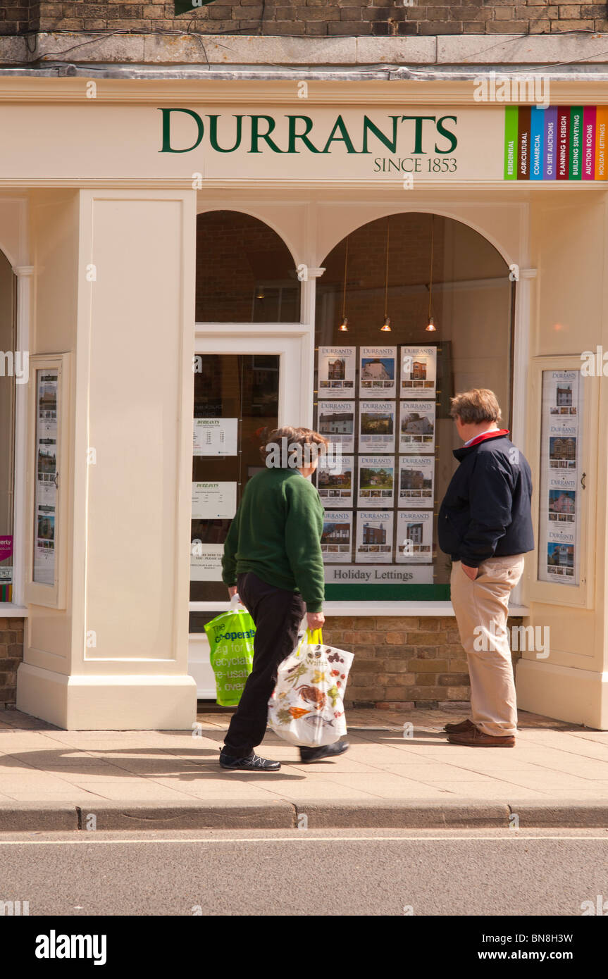 People Viewing The Durrants Estate Agent Window At Southwold Stock