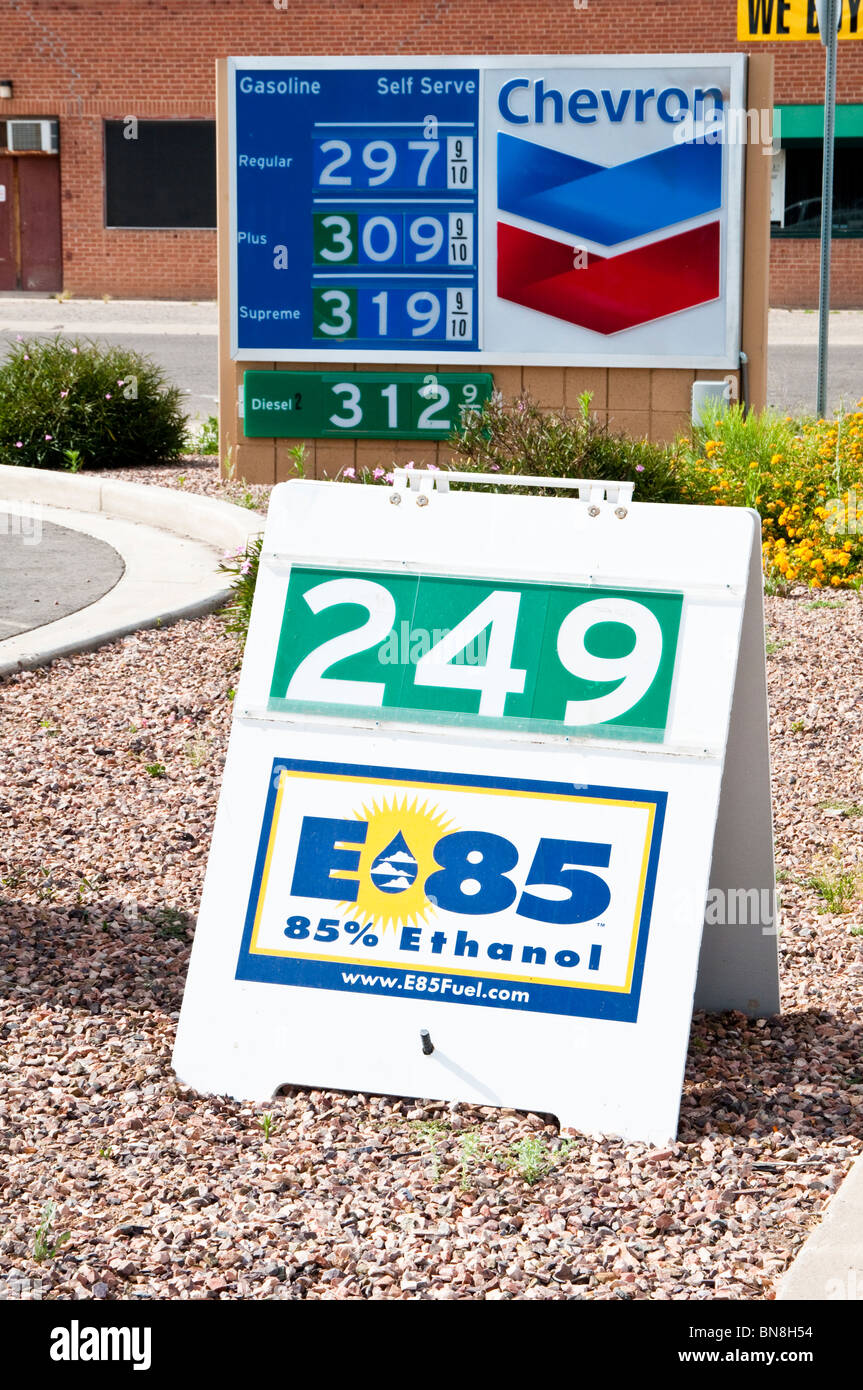 A sign advertises E85 85% ethanol blended fuel in front of a price sign for regular, plus, supreme and diesel fuels. Stock Photo