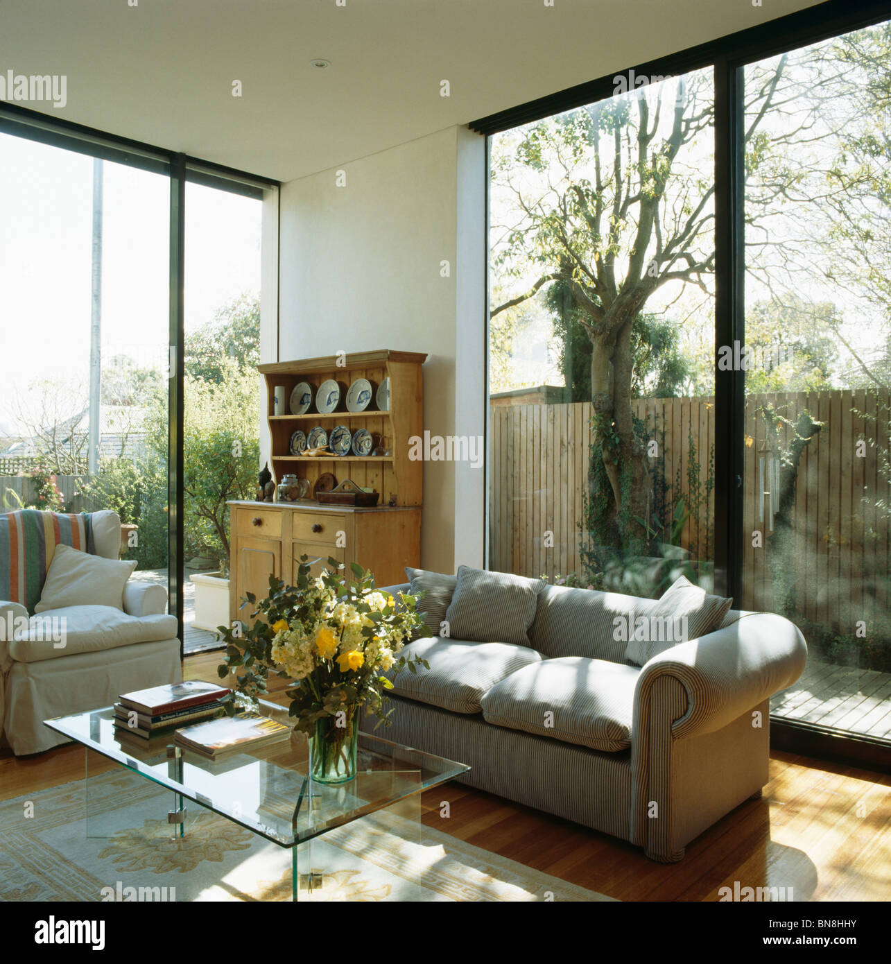 Grey Sofa In Front Of Patio Doors In Modern White Living Room