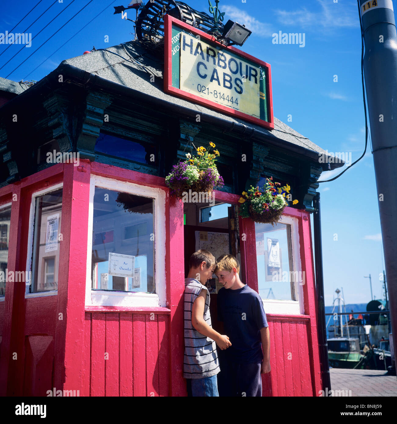 2 BOYS AT HARBOUR CABS CABMEN'S SHELTER COBH COUNTY CORK IRELAND Stock Photo Alamy