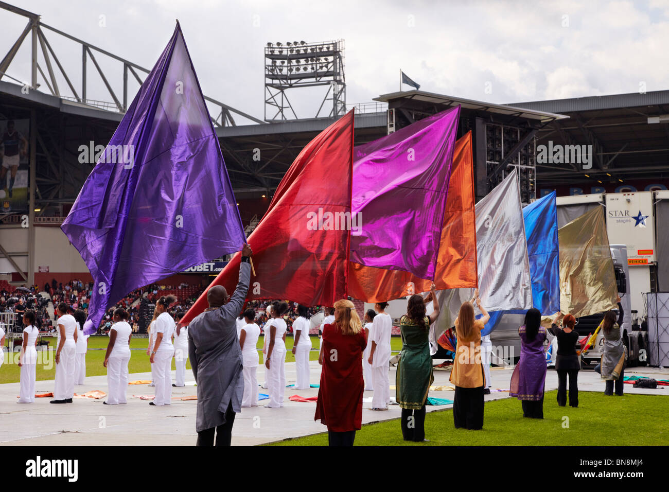 Dancers with flags at the 2010 London Global Day of Prayer. West Ham United Football Club, Upton Park, London, England. Stock Photo