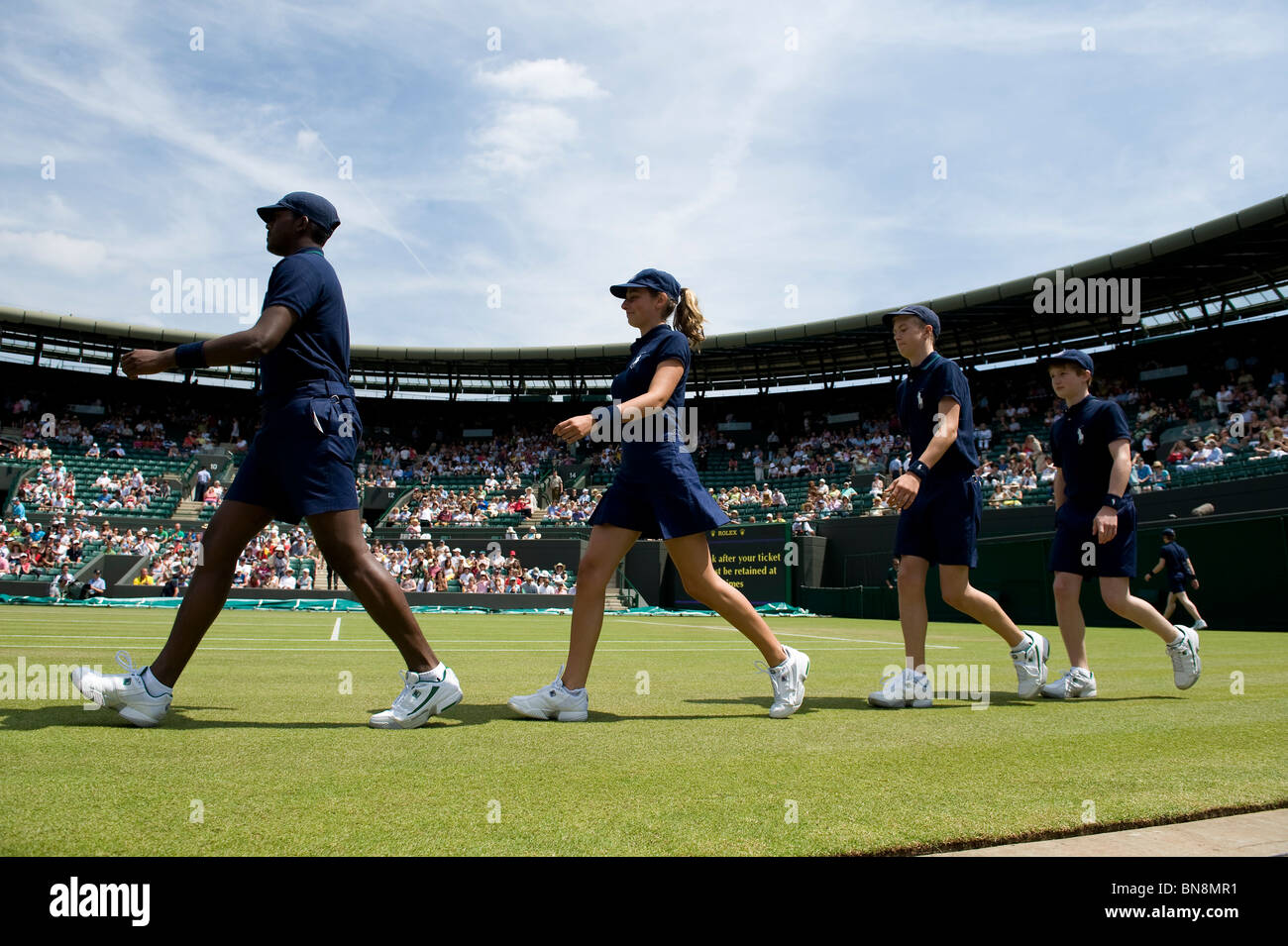 Ball boys and girls walk out onto court 1 during the Wimbledon Tennis Championships 2010 Stock Photo