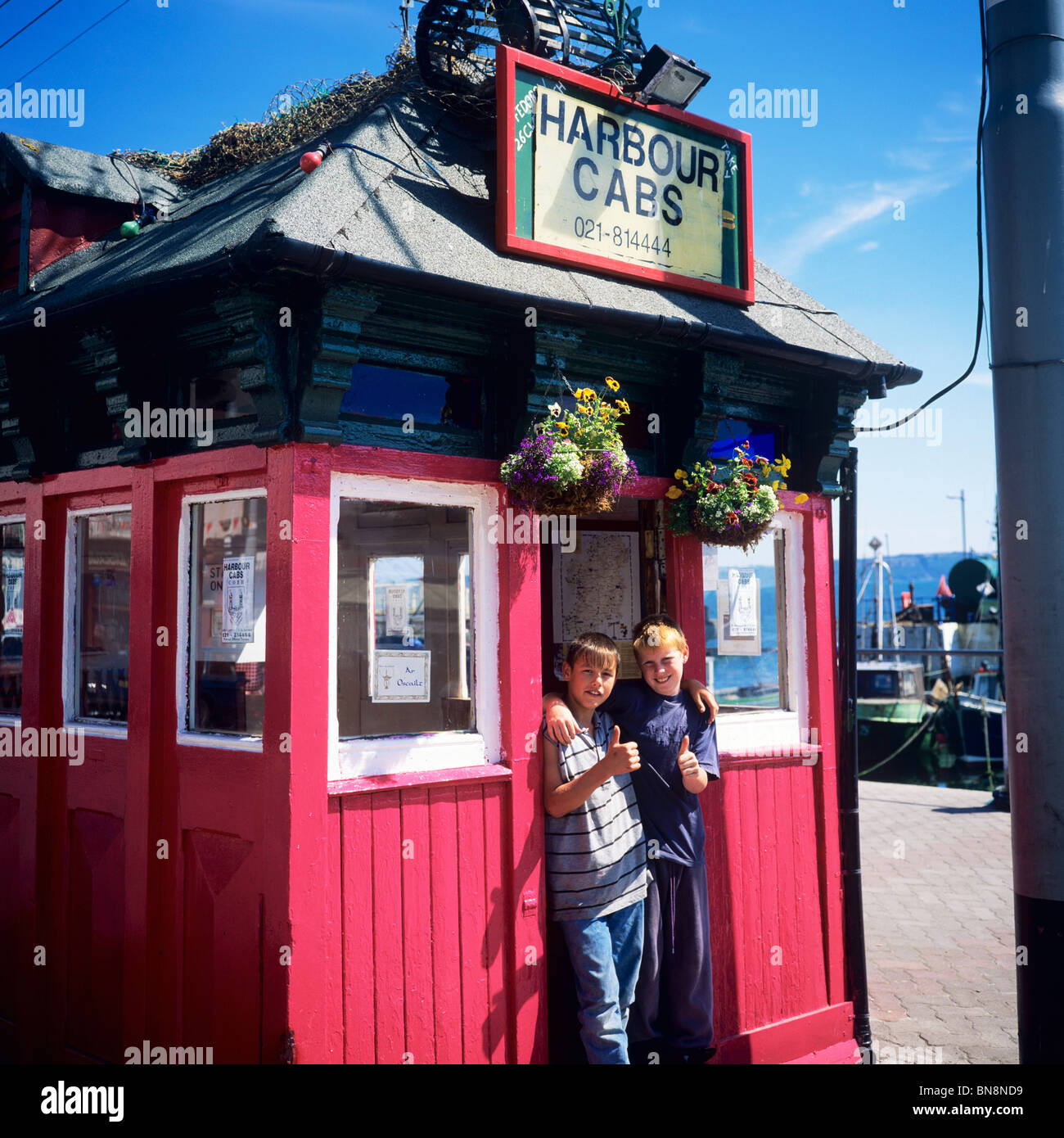2 BOYS AT HARBOUR CABS CABMEN'S SHELTER COBH COUNTY CORK IRELAND Stock Photo Alamy