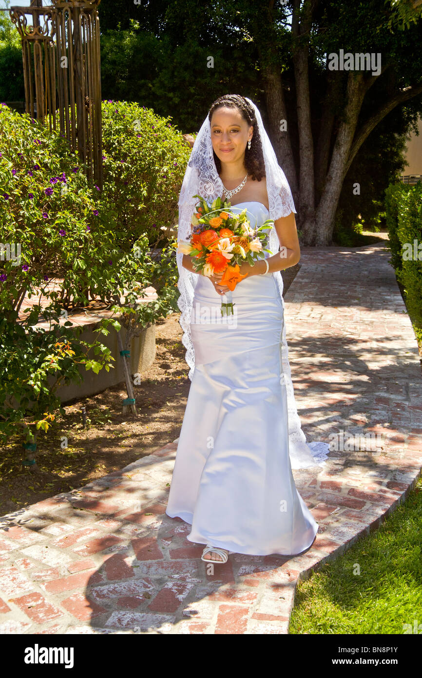 A mixed-race bride at her formal outdoor wedding ceremony in Orange, CA. MODEL RELEASE Stock Photo