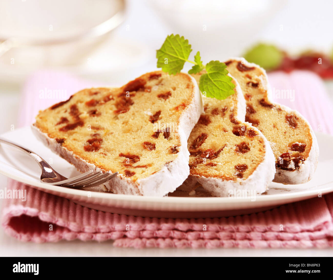 Slices of stollen cake with raisins and candied fruit Stock Photo