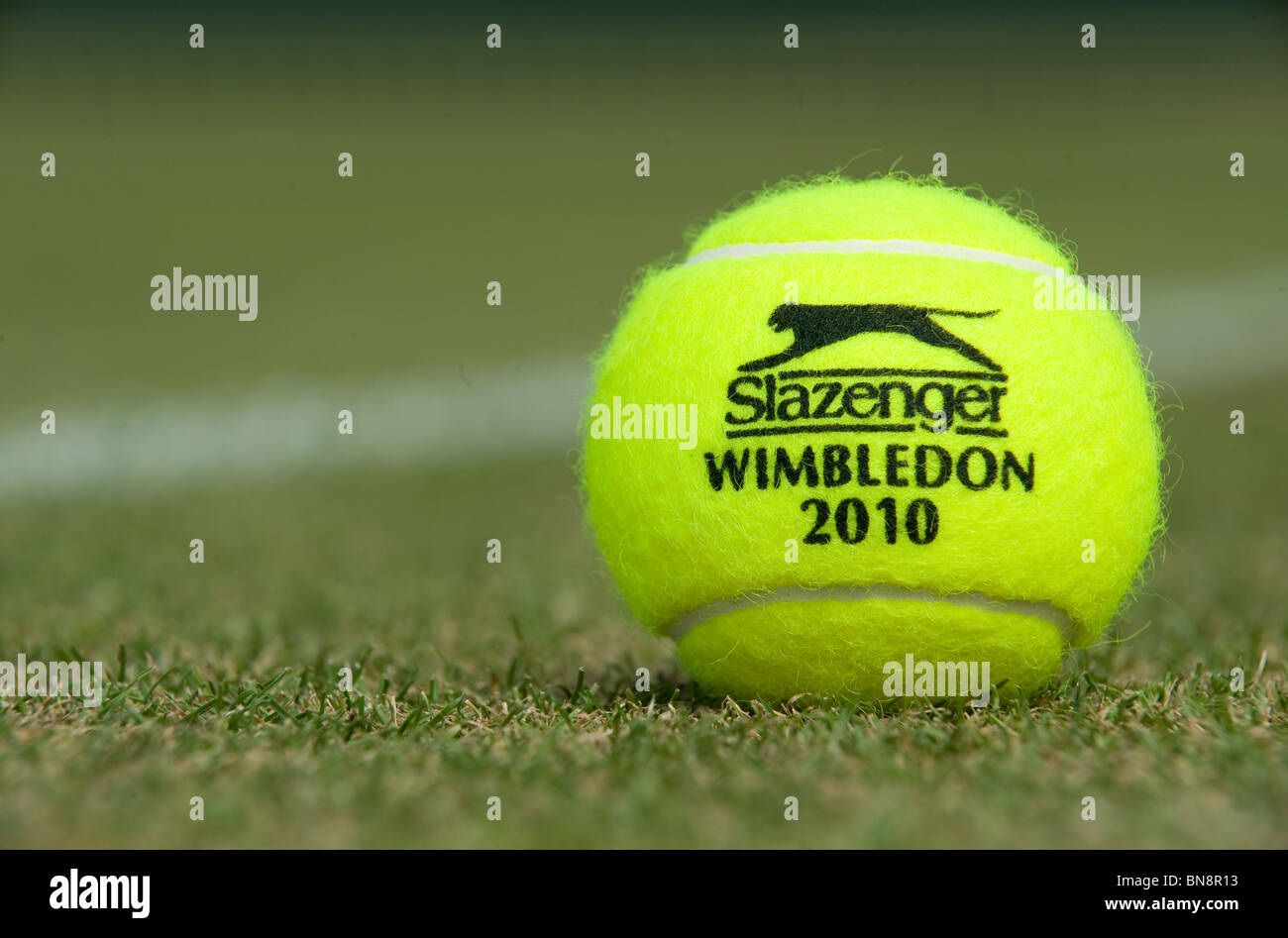 Wimbledon 2010 Slazenger tennis ball sits on a grass court during the Wimbledon Tennis Championships 2010  Stock Photo