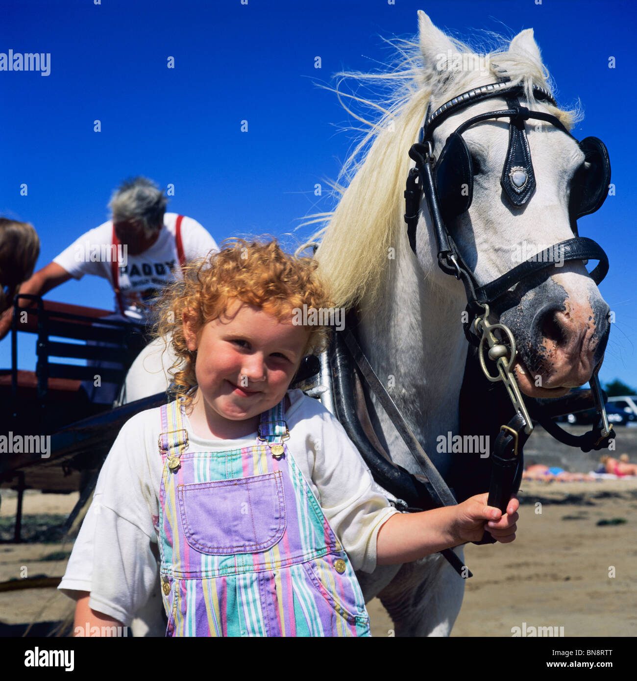 RED HAIRED LITTLE GIRL & WHITE HORSE IRELAND EUROPE Stock Photo