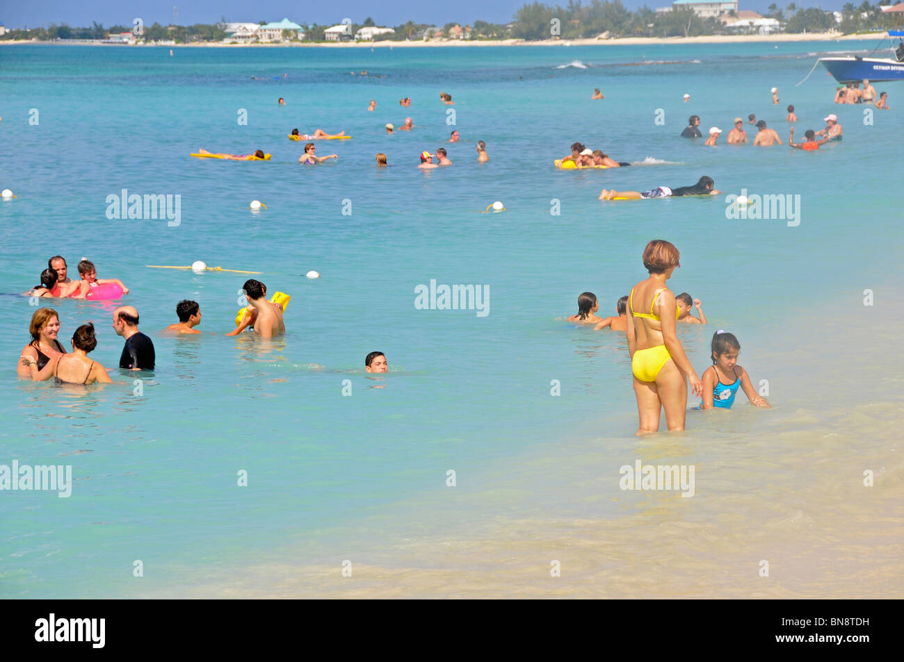 Toruists enjoy Beaches at Grand Cayman Islands Caribbean Stock Photo