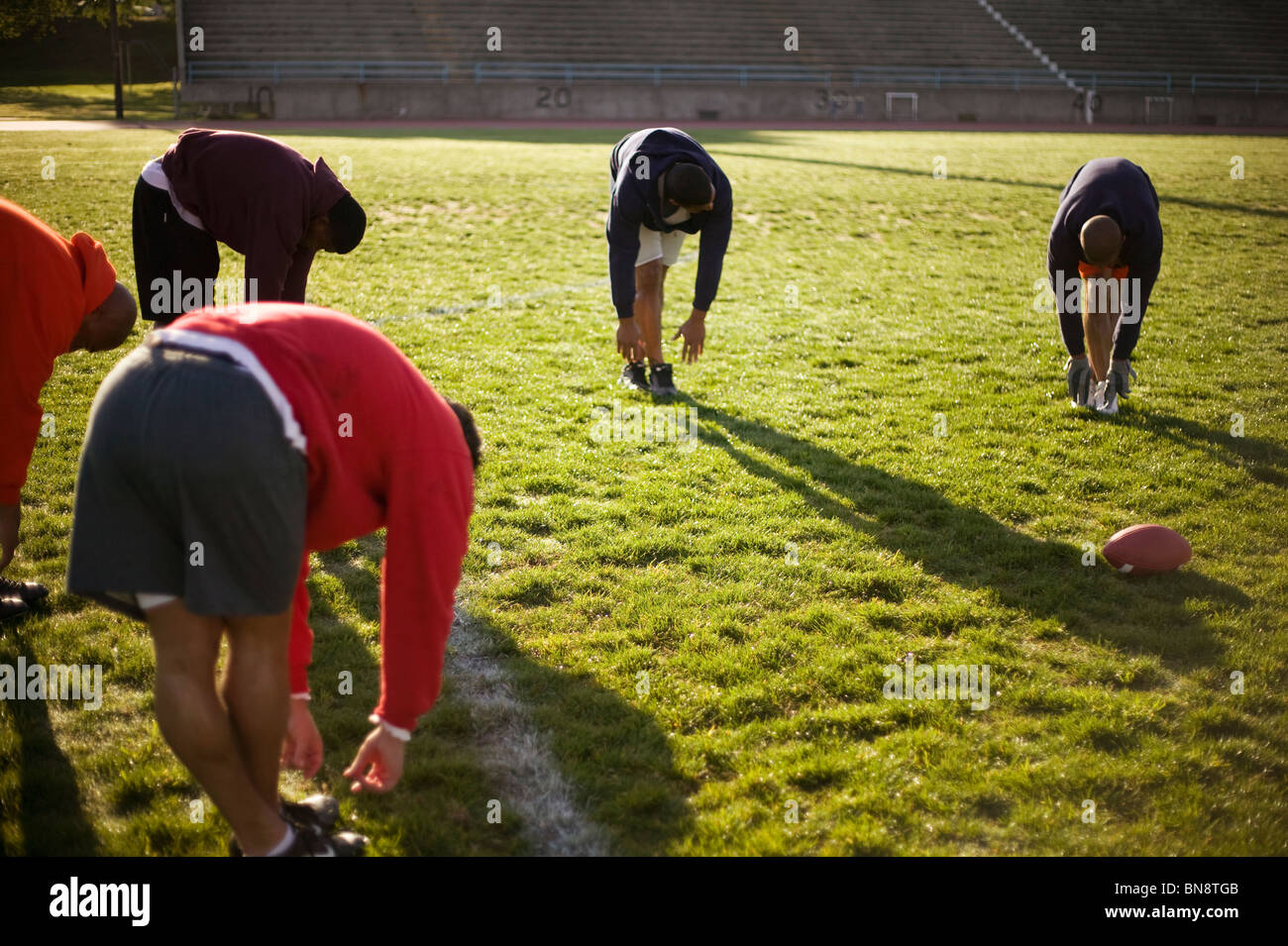 Men training on football field Stock Photo