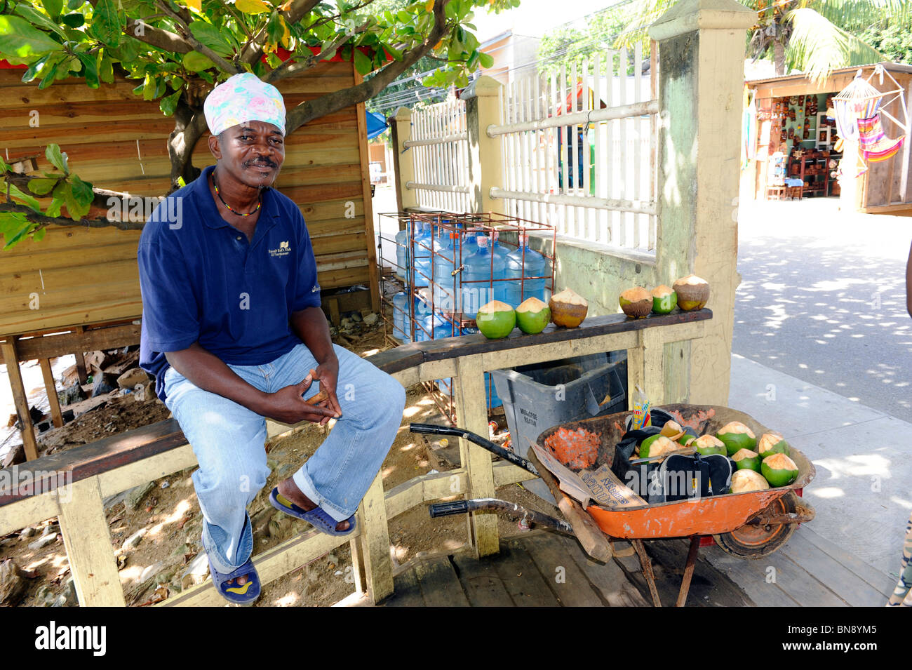 Native Honduran male sells coconuts near Caribbean Cruise ship in Isla
