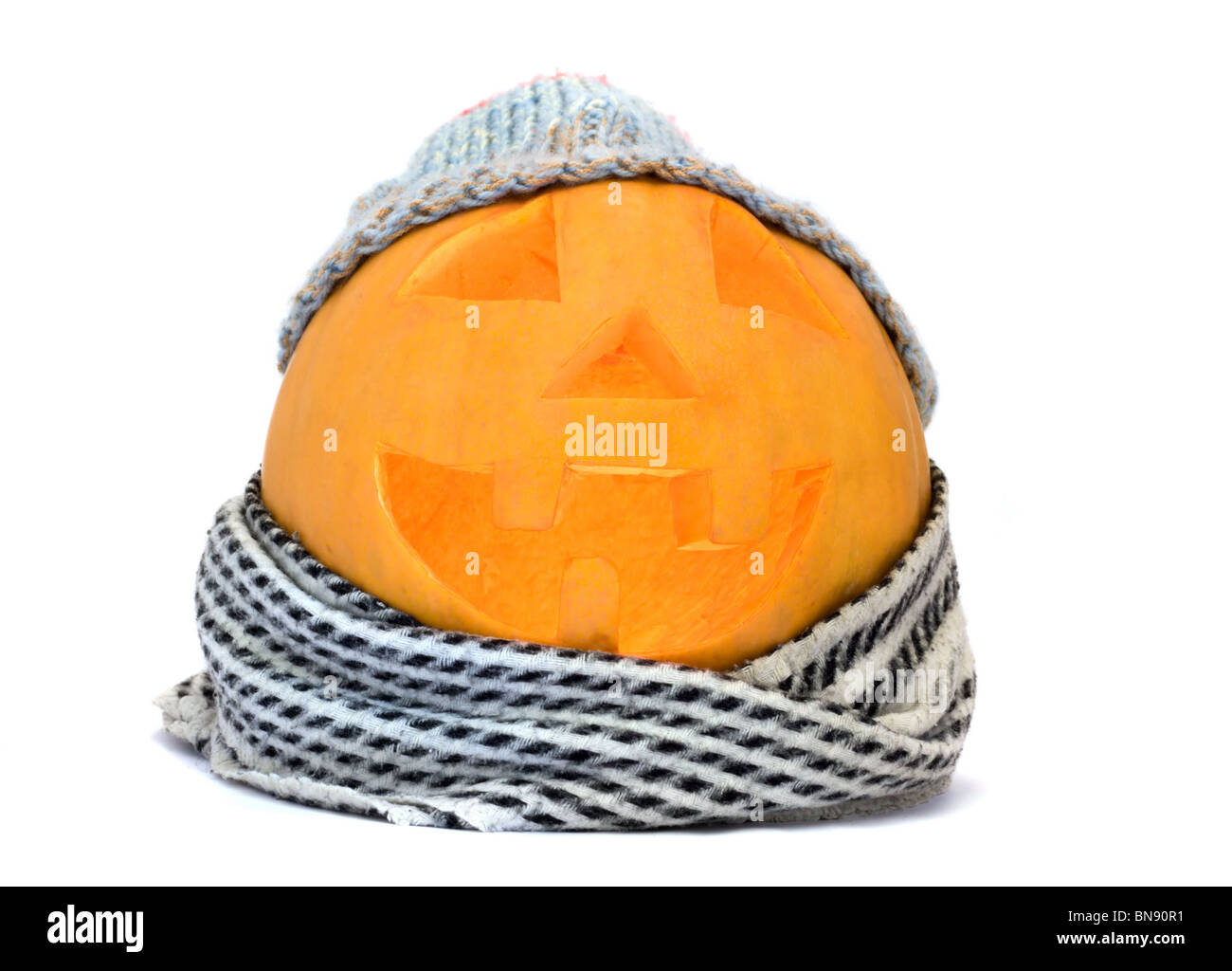 Halloween pumpkin face with hat and scarf isolated on white Stock Photo