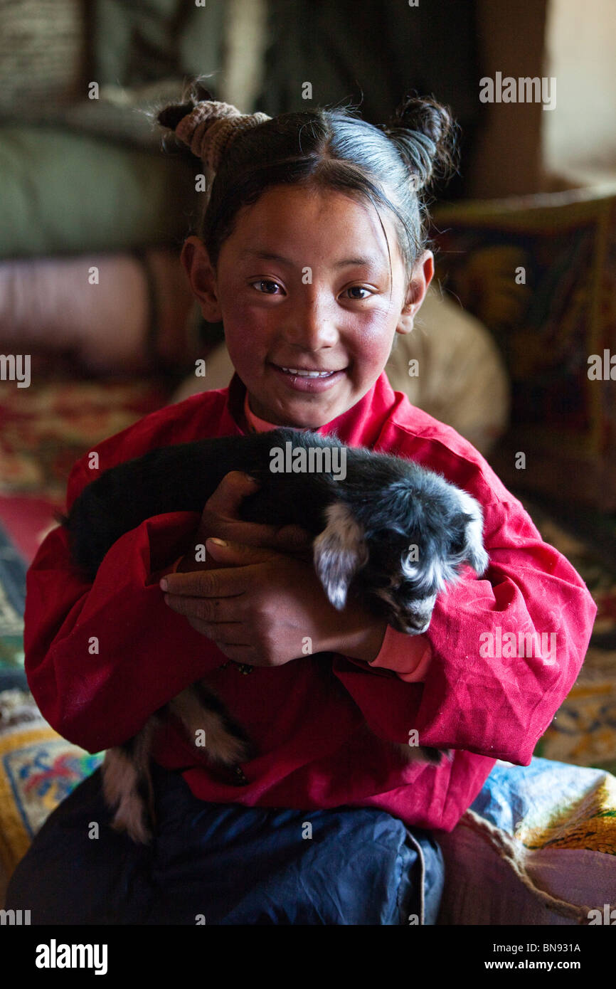 Young girl holding a baby lamb in rural Tibet Stock Photo - Alamy