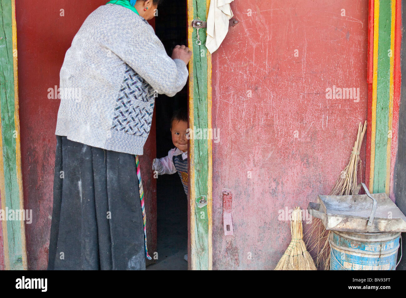 Grandmother and Tibetan boy in a doorway in Gyantse, Tibet Stock Photo