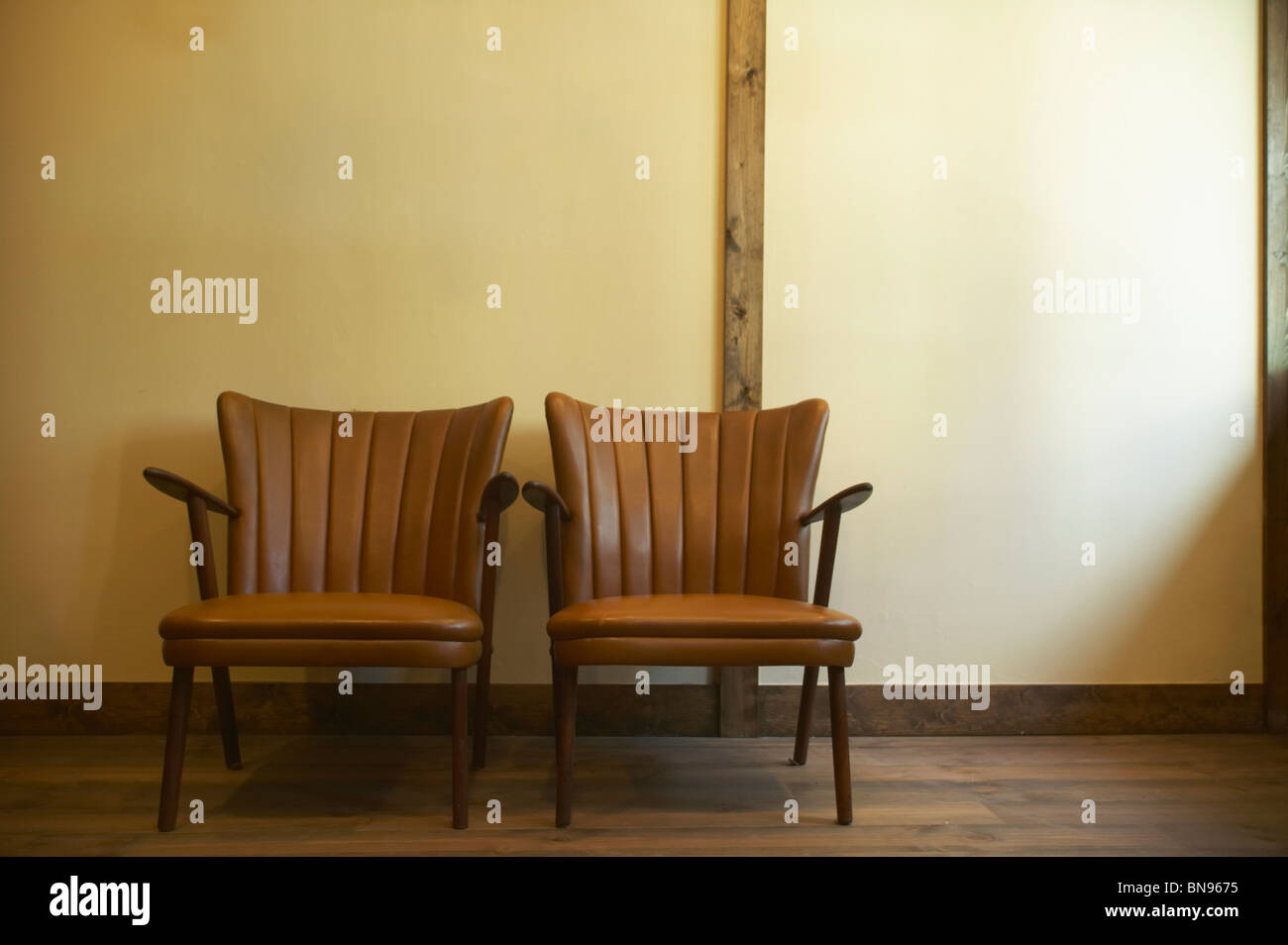 Two brown leather chairs Stock Photo - Alamy