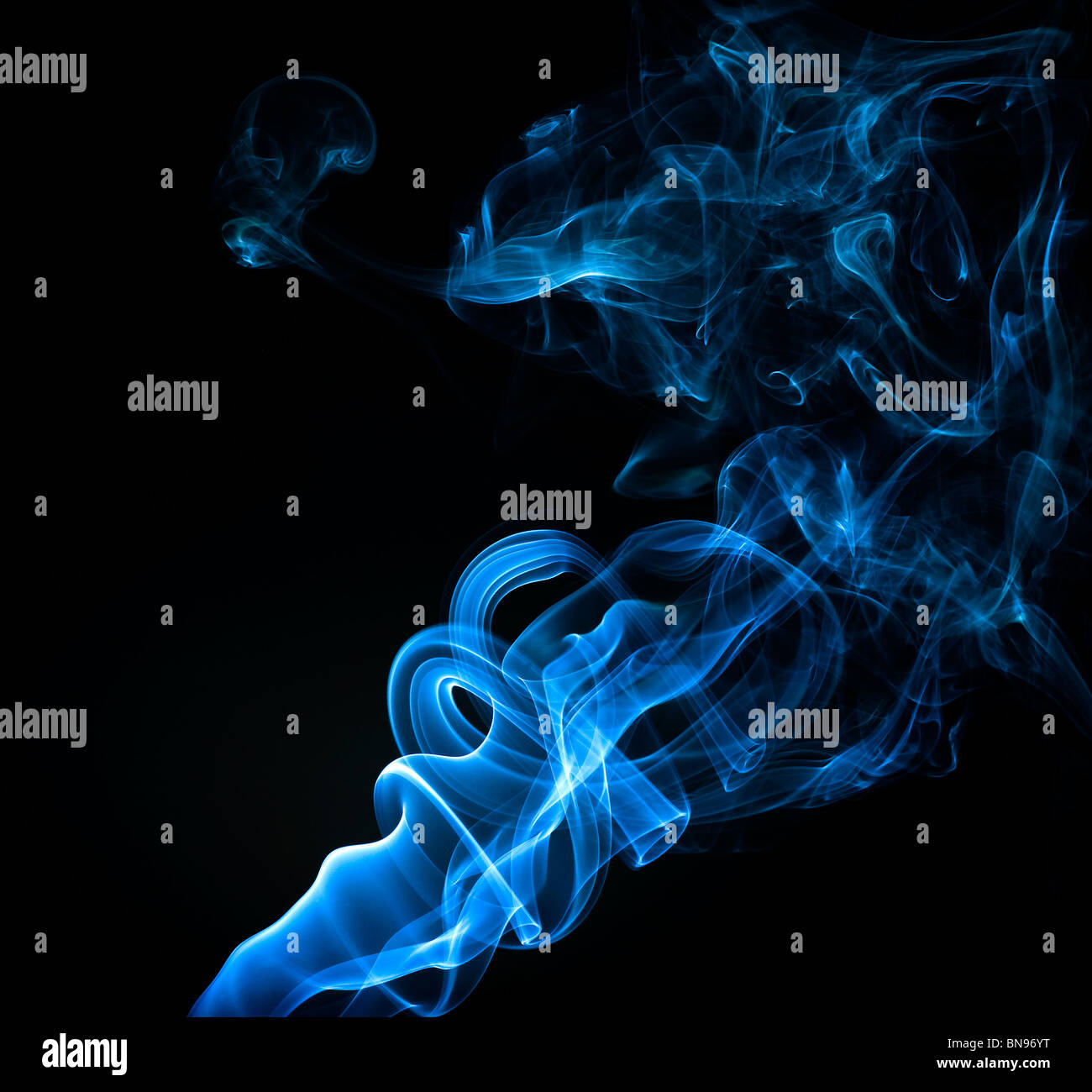 Abstract blue smoke trails on a black background Stock Photo - Alamy