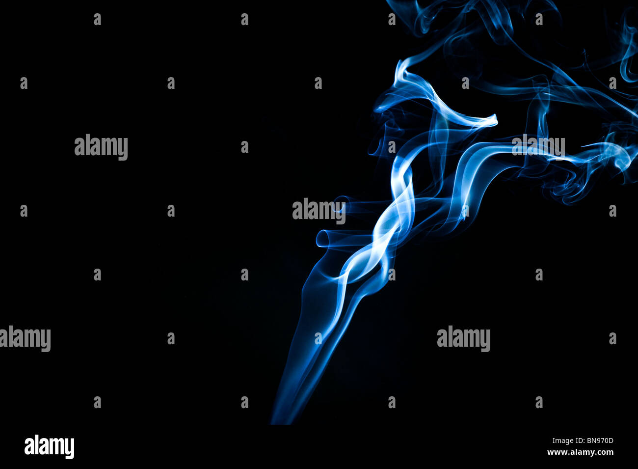 Abstract blue smoke trails on a black background Stock Photo - Alamy
