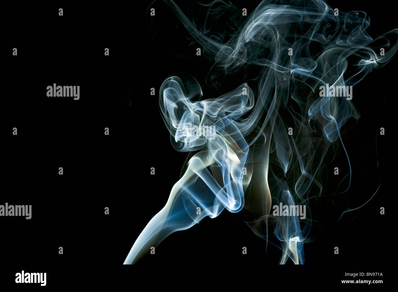 Abstract blue smoke trails on a black background Stock Photo - Alamy