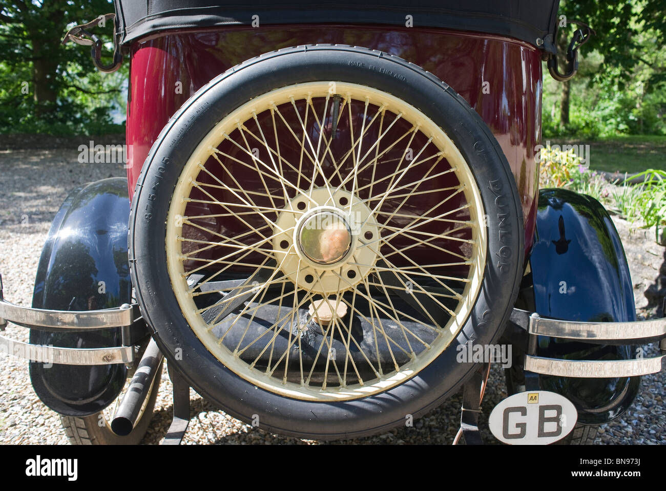 Spare spoked wheel on back of old Buick saloon carrear, spare wheel Stock Photo