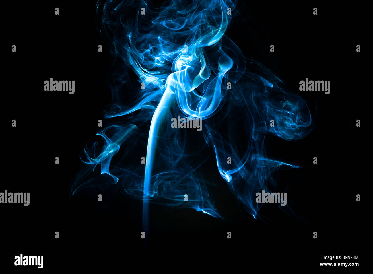 Abstract blue smoke trails on a black background Stock Photo - Alamy